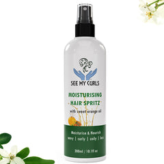 A 300ml (10.1 fl oz) spray bottle of "See My Curls Moisturising Hair Spritz with sweet orange oil." The bottle features a white label with a teal blue logo of hands cradling a curly hair graphic, green and blue text, and a dark teal bottom section reading "Moisturise & Nourish | wavy | curly | coily | locs." The product is centered against a white background framed by subtle white flowers and green leaves in the corners.