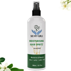 A 300ml (10.1 fl oz) spray bottle of "See My Curls Moisturising Hair Spritz," explicitly labeled as "unscented." The bottle features a white label with a teal blue logo of hands cradling a curly hair graphic, green and blue text, and a dark teal bottom band reading "Moisturise & Nourish | wavy | curly | coily | locs." The product is centered against a white background with subtle white flowers and green leaves peeking into the bottom left corner.